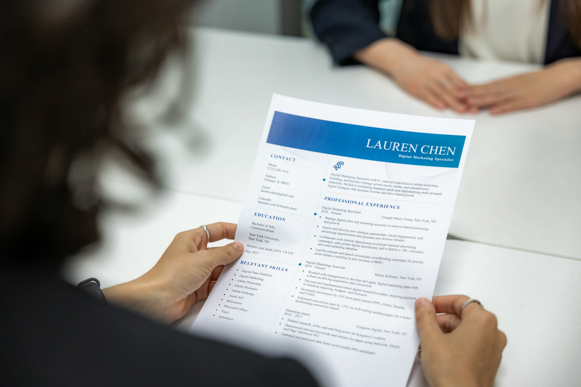 A professional carefully reviewing a resume